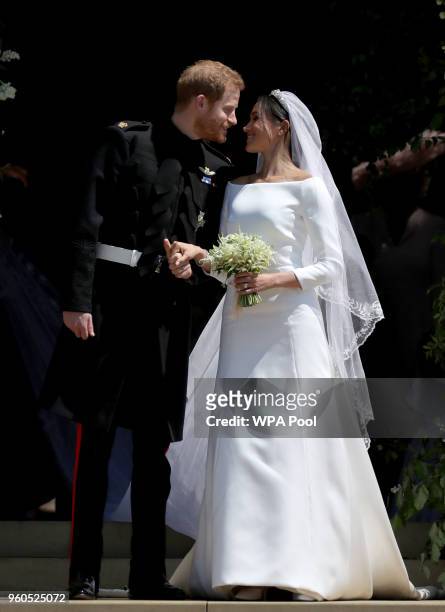Prince Harry, Duke of Sussex and The Duchess of Sussex share a kiss after their wedding at St George's Chapel at Windsor Castle on May 19, 2018 in...