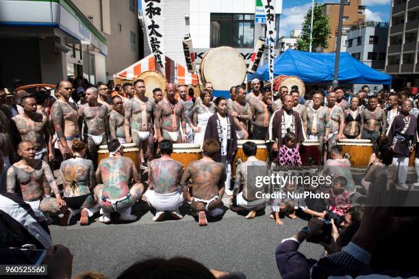 Heavily tattooed Japanese men and women pose for photo with their family during Tokyo's one of the largest three day festival called &quot;Sanja...