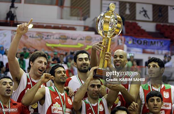 Players of Iran's Mahram club celebrate with the trophy after winning the Dubai International Basketball Tournament in the Gulf emirate on January...