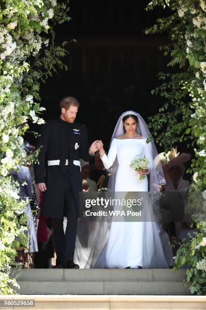 Prince Harry, Duke of Sussex and the Duchess of Sussex depart after their wedding ceremony at St George's Chapel at Windsor Castle on May 19, 2018 in...