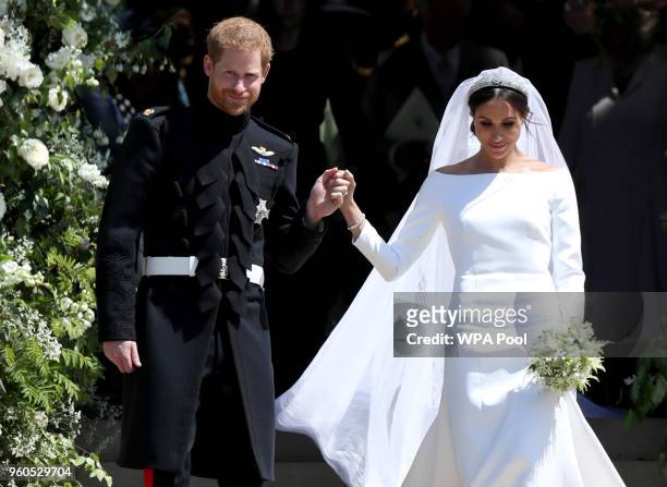 Prince Harry, Duke of Sussex and the Duchess of Sussex depart after their wedding ceremony at St George's Chapel at Windsor Castle on May 19, 2018 in...