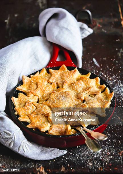 sweet pie with apple fruit and cinnamon covered with sweet short crust pastry in the shape of stars dusted with brown sugar on a wooden table, selective focus. american apple pie. sweet food. - shortcrust pastry stock pictures, royalty-free photos & images
