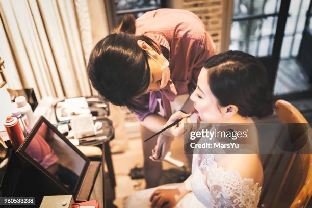 wedding makeup artist making a make up for bride - bridesmaid stock pictures, royalty-free photos & images