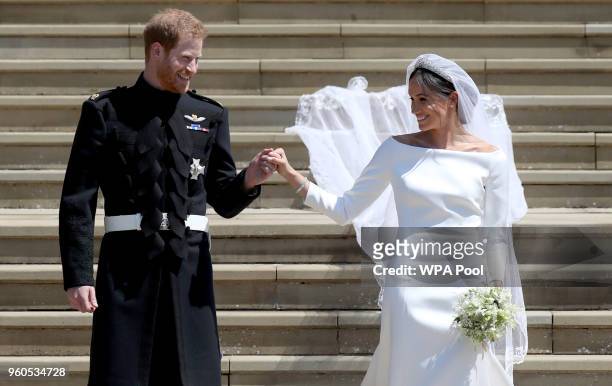Prince Harry, Duke of Sussex and the Duchess of Sussex depart after their wedding ceremonyat St George's Chapel at Windsor Castle on May 19, 2018 in...