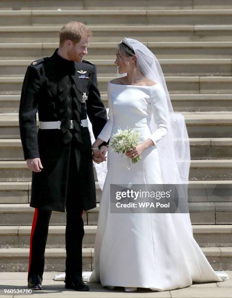 Prince Harry, Duke of Sussex and the Duchess of Sussex depart after their wedding ceremonyat St George's Chapel at Windsor Castle on May 19, 2018 in...