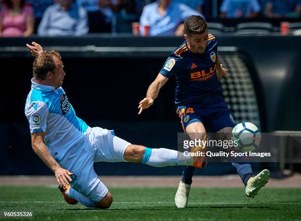 Jose Luis Gaya of Valencia competes for the ball with Michael Krohn-Dehli of Deportivo de La Coruna during the La Liga match between Valencia and...