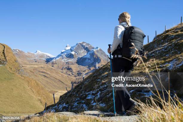 female hiker descends trail from above grindelwald, swiss alps - eiger stock pictures, royalty-free photos & images