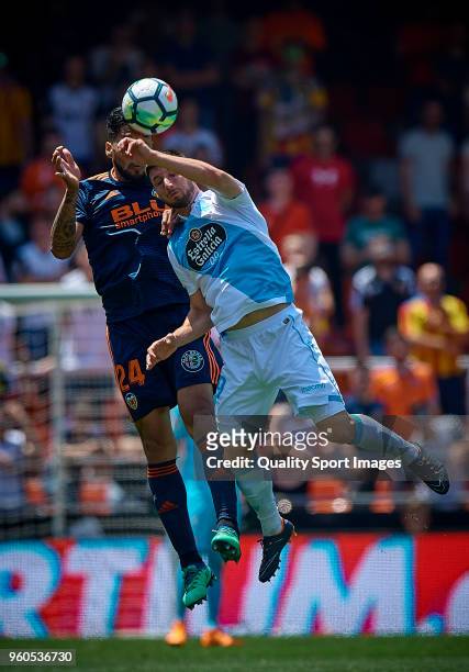 Ezequiel Garay of Valencia competes for the ball with Borja Valle of Deportivo de La Coruna during the La Liga match between Valencia and Deportivo...