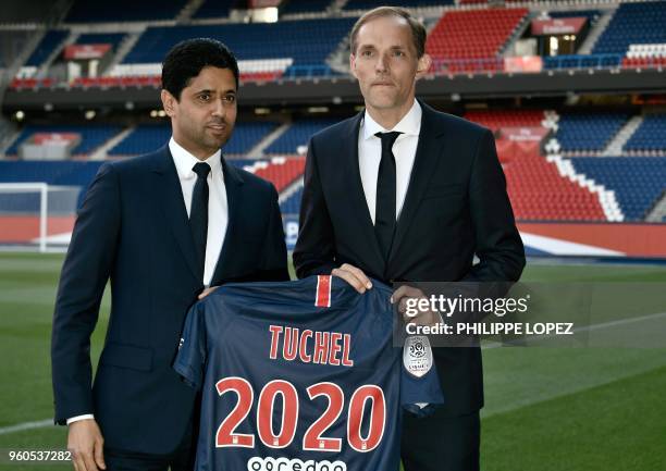 French Ligue 1 football club Paris Saint-Germain's newly appointed coach German Thomas Tuchel poses with club's president Nasser Al-Khelaifi after a...