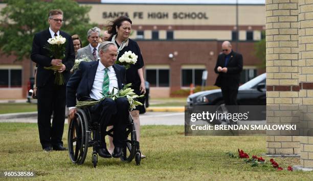 Texas Governor Greg Abbott , his wife Cecilia Abbott, Lieutenant Governor Dan Patrick and other officials bring flowers for a makeshift memorial on...