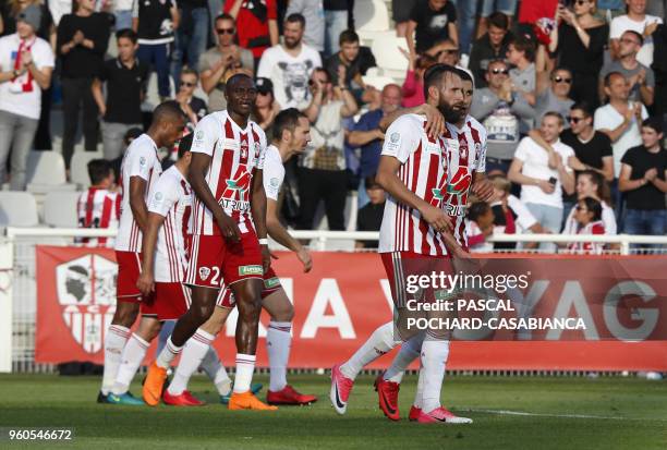 Ajaccio's French Forward Ghislain Gimbert celebrates with his teammates after scoring a goal during the French second-division playoff between AC...