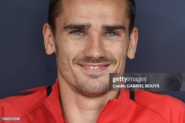 Atletico Madrid's French forward Antoine Griezmann smiles on the bench during the Spanish league football match between Club Atletico de Madrid and...