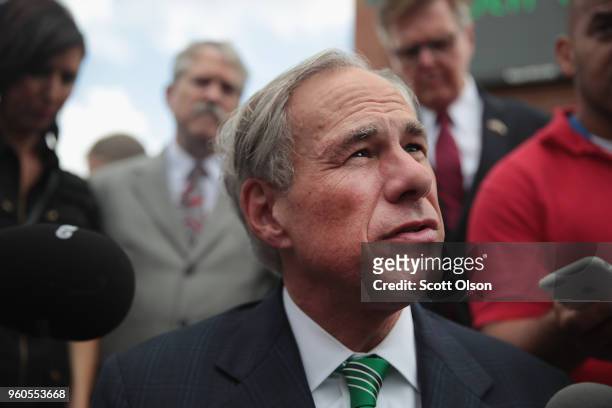 Texas Governor Greg Abbott speaks to the press during a visit to Santa Fe High School on May 20, 2018 in Santa Fe, Texas. Last Friday, 17-year-old...