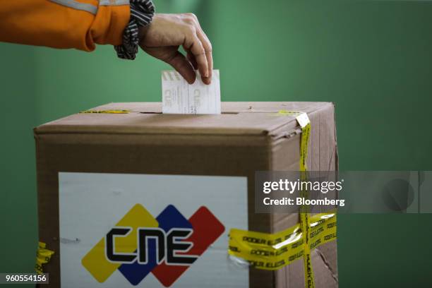 Voter casts a ballot inside a polling station during presidential elections in Caracas, Venezuela, on Sunday, May 20, 2018. Venezuela holds an...