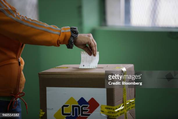 Voter casts a ballot inside a polling station during presidential elections in Caracas, Venezuela, on Sunday, May 20, 2018. Venezuela holds an...