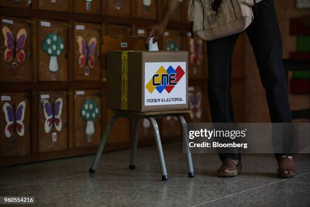 Voter casts a ballot inside a polling station during presidential elections in Caracas, Venezuela, on Sunday, May 20, 2018. Venezuela holds an...