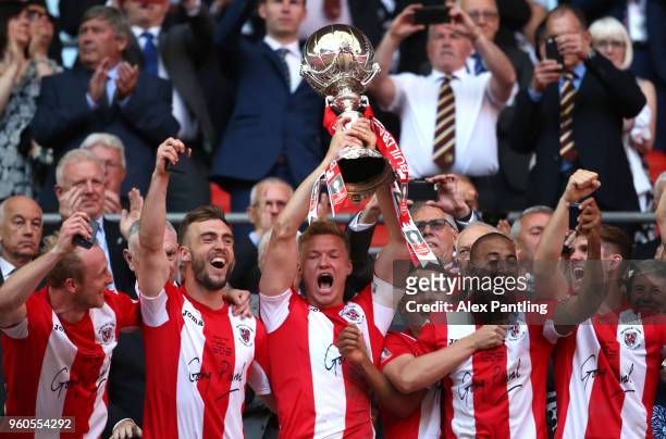 Gareth Dean of Brackley Town lifts the trophy as he celebrates ictory during the Buildbase FA Trophy Final between Brackley Town and Bromley FC at...