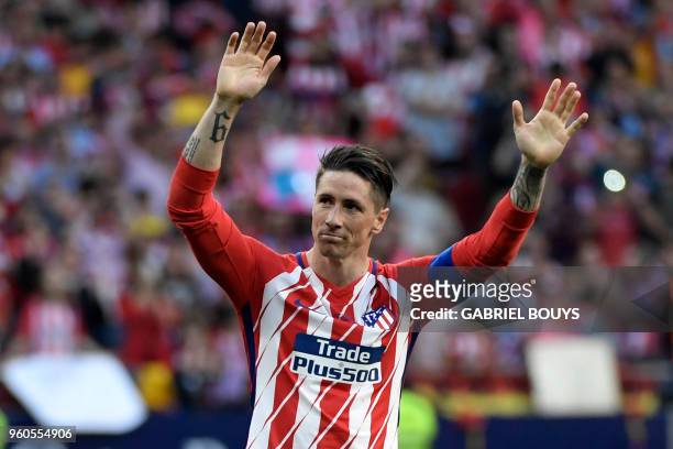 Atletico Madrid's Spanish forward Fernando Torres acknowledges fans at the end of the Spanish league football match between Club Atletico de Madrid...