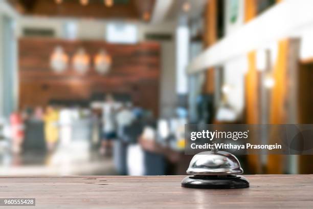 hotel service bell on a table white glass and simulation hotel background. concept hotel, travel, room"n - hotel bell stockfoto's en -beelden