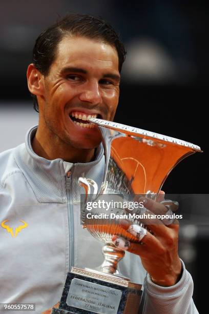 Rafael Nadal of Spain celebrate by biting the trophy after victory in his Mens Final match against Alexander Zverev of Germany during day 8 of the...
