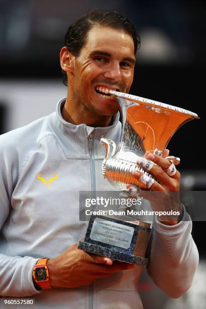 Rafael Nadal of Spain celebrate by biting the trophy after victory in his Mens Final match against Alexander Zverev of Germany during day 8 of the...