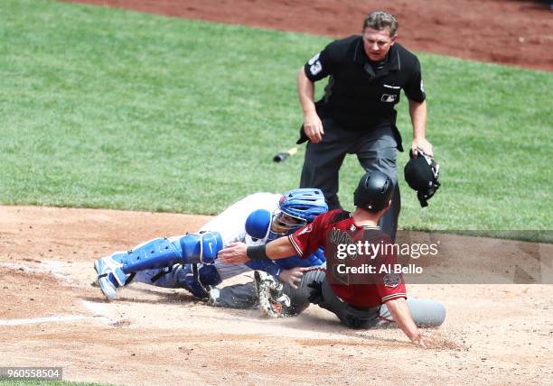 Jeff Mathis of the Arizona Diamondbacks is tagged out by Tomas Nido of the New York Mets in the fifth inning during their game at Citi Field on May...