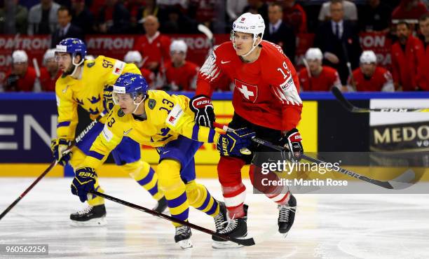 Mattias Janmark of Sweden and Gregory Hofmann of Switzerland battle for the puck during the 2018 IIHF Ice Hockey World Championship Gold Medal Game...