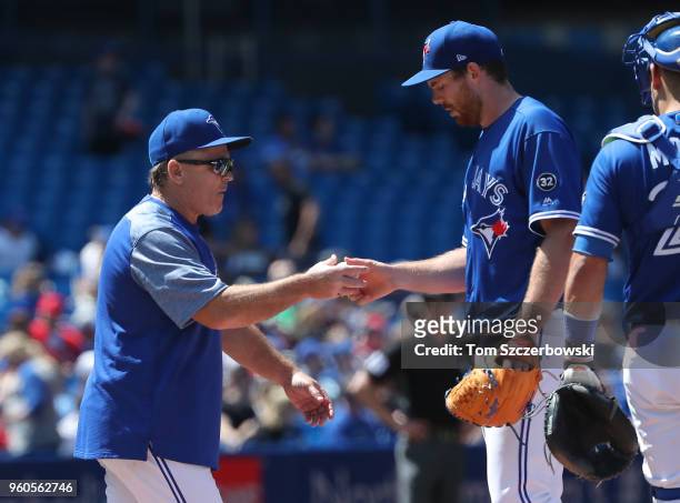 Joe Biagini of the Toronto Blue Jays exits the game as he is relieved by manager John Gibbons in the fifth inning during MLB game action against the...