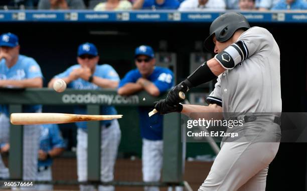 Austin Romine of the New York Yankees breaks his bat as he hits a RBI single in the fourth inning against the Kansas City Royals at Kauffman Stadium...