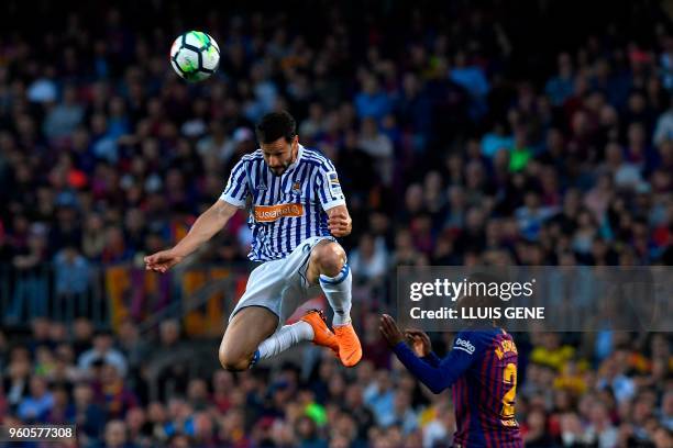 Real Sociedad's Spanish defender Alberta De la Bella heads the ball next to Barcelona's Portuguese defender Nelson Semedo during the Spanish league...