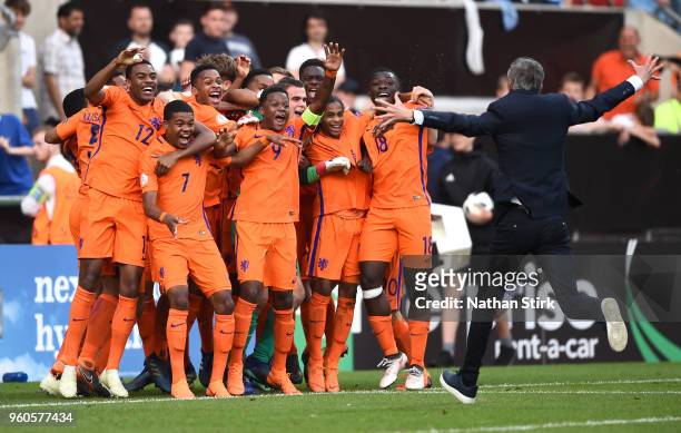 Kees Van Wonderen, manager of the Netherlands runs to his players to celebrate winning after the UEFA European Under-17 Championship Final between...
