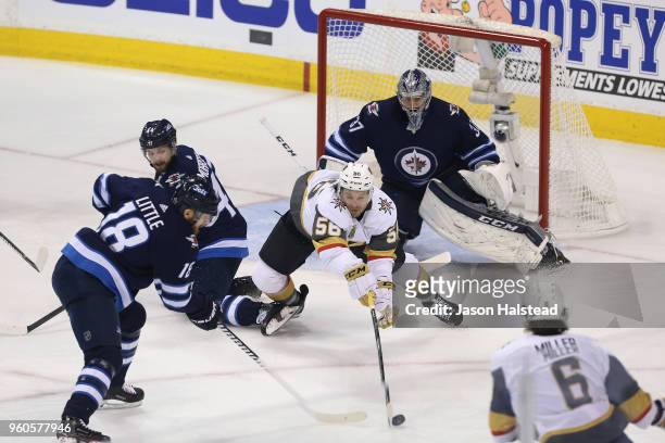 Erik Haula of the Vegas Golden Knights battles for the puck with Bryan Little of the Winnipeg Jets during the first period in Game Five of the...