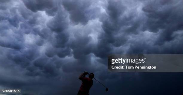 Russell Knox of Scotland plays his shot from the first tee after a four hour rain delay during the final round of the AT&T Byron Nelson at Trinity...