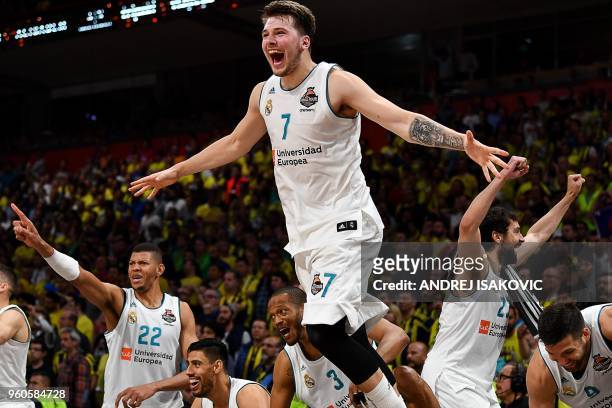 Real Madrid's Slovenian Luka Doncic jumps over the barrier as the team celebrates their 85-80 win in the Euroleague Final Four finals basketball...