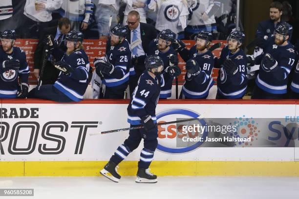 Josh Morrissey of the Winnipeg Jets celebrates with teammates after scoring a first period goal against the Vegas Golden Knights in Game Five of the...