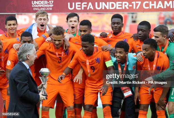 Ireland FA Chief Executive John Delaney presents Netherlands' Daishawn Redan with the trophy during the UEFA European U17 Championship final at the...