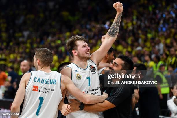 Real Madrid's Slovenian Luka Doncic celebrates with team mate Real Madrid's French forward Fabien Causeur their team's 85-80 win in the Euroleague...