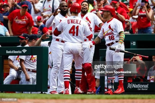 St. Louis Cardinals' Tyler O'Neill is congratulated after hitting a solo homer by Dexter Fowler, left, Francisco Pena, center and Kolten Wong, right,...