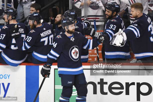 Josh Morrissey of the Winnipeg Jets celebrates with teammates after scoring a first period goal against the Vegas Golden Knights in Game Five of the...