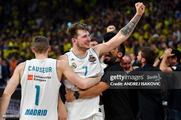 Real Madrid's Slovenian Luka Doncic celebrates with team mate Real Madrid's French forward Fabien Causeur their team's 85-80 win in the Euroleague...