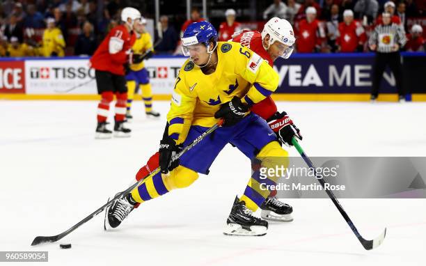 Rickard Rakell of Sweden and Nino Niederreiter of Switzerland battle for the puck during the 2018 IIHF Ice Hockey World Championship Gold Medal Game...