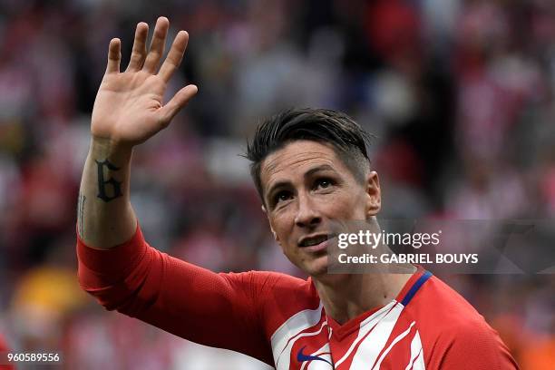 Atletico Madrid's Spanish forward Fernando Torres waves at fans during a tribute at the end of the Spanish league football match between Club...