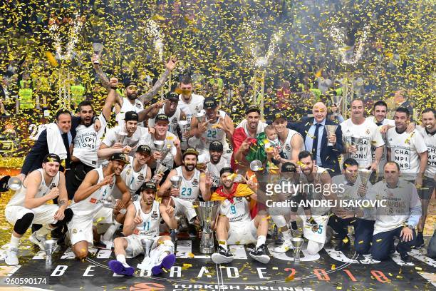 Real Madrid basketball players pose with the trophy as they celebrate their team's 85-80 win in the Euroleague Final Four finals basketball match...