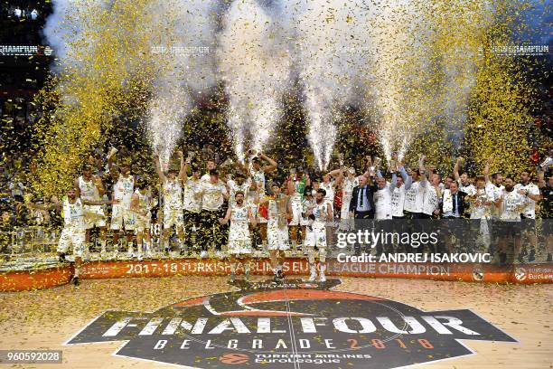 Real Madrid basketball players celebrate with the trophy their team's 85-80 win in the Euroleague Final Four finals basketball match between Real...