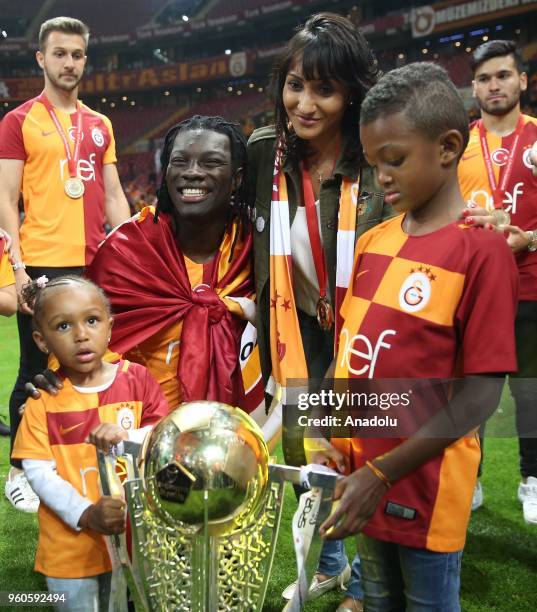 Galatasaray's players Bafetimbi Gomis poses with the trophy with his family as they celebrate the 21st Turkish Super League championship title at...