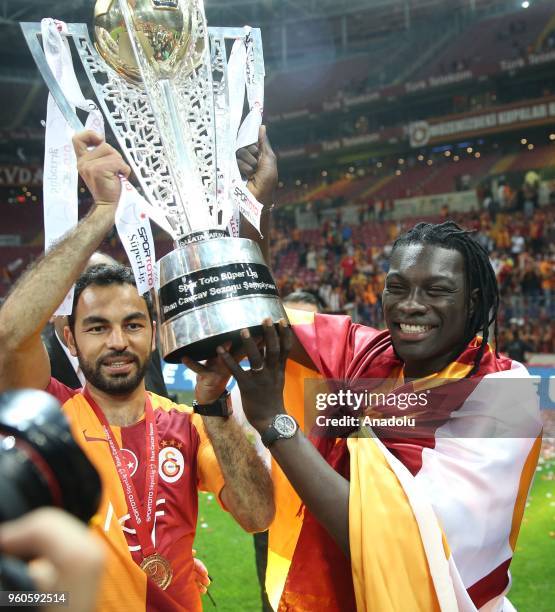 Galatasaray's players Bafetimbi Gomis poses with the trophy with his family as they celebrate the 21st Turkish Super League championship title at...