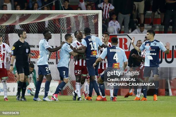Ajaccio's French defender Cedric Avinel argues with Le Havre's French midfielder Jean-Philippe Mateta during the French second-division playoff...