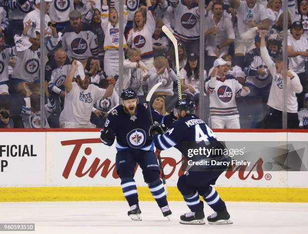 Bryan Little and Josh Morrissey of the Winnipeg Jets celebrate a first period goal against the Vegas Golden Knights in Game Five of the Western...