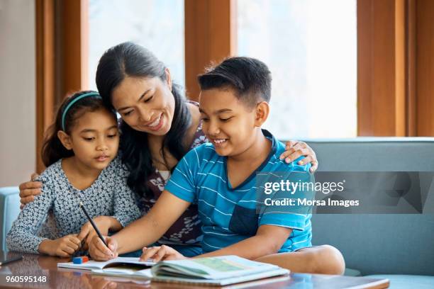 family working on school project at home - son daughter stock pictures, royalty-free photos & images