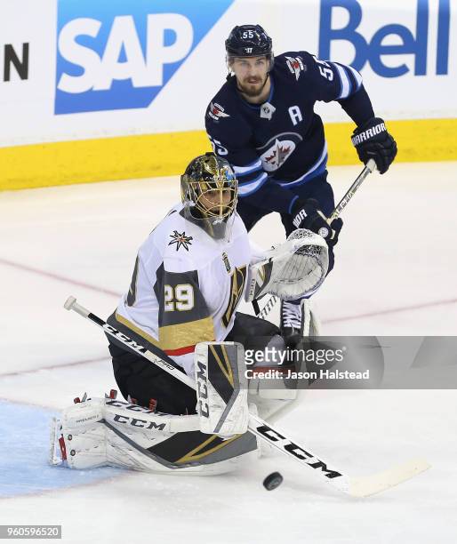 Marc-Andre Fleury of the Vegas Golden Knights and Mark Scheifele of the Winnipeg Jets watch the puck during the first period in Game Five of the...